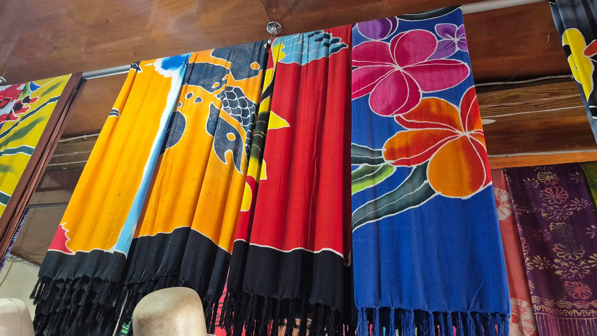 Hand-painted sarongs in bright colours at a Bali textile supplier, sourced by ExportBali