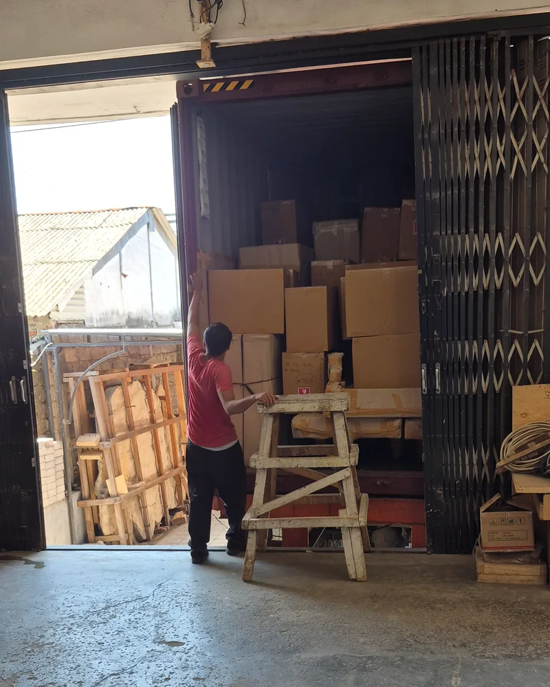 Cartons being loaded into an export container at a Bali warehouse