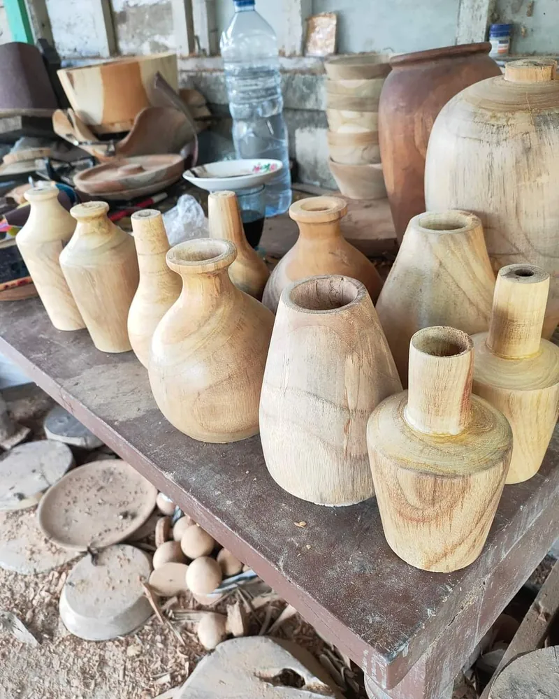 Hand-turned wooden vases on a Bali workshop bench, sourced by ExportBali