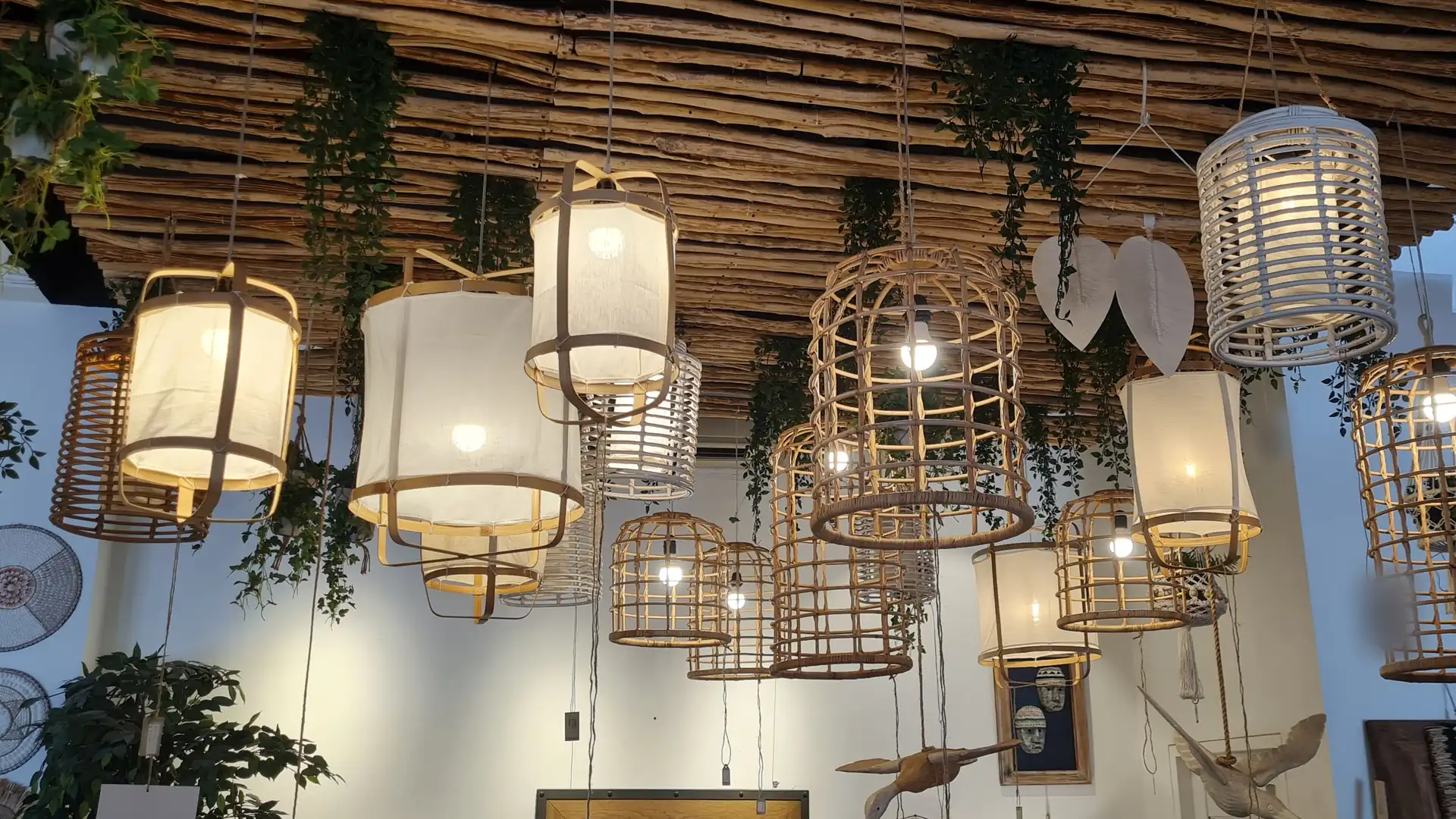 Handmade woven pendant lights hanging in a Bali lighting shop, sourced by ExportBali