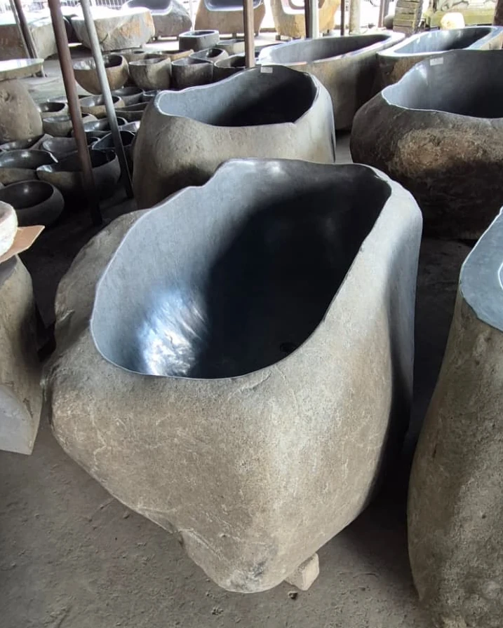 Natural river stone bathtub with a smooth honed interior