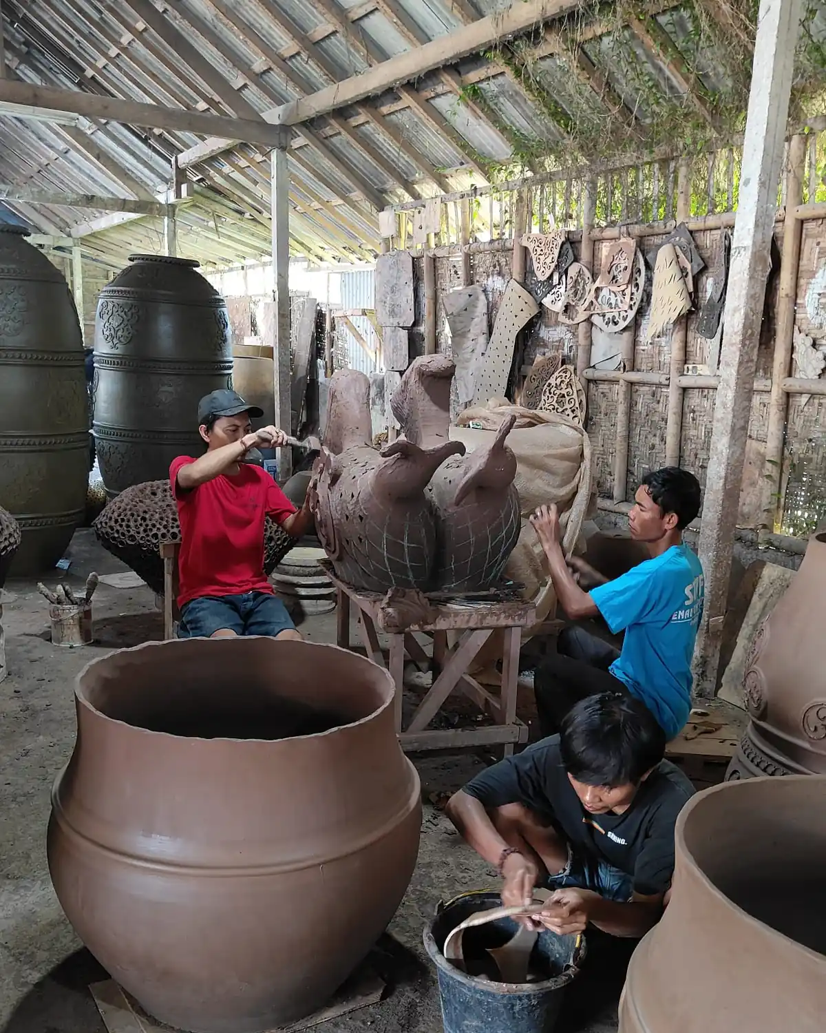 Craftsmen shaping large clay pots in a Bali pottery workshop, ExportBali