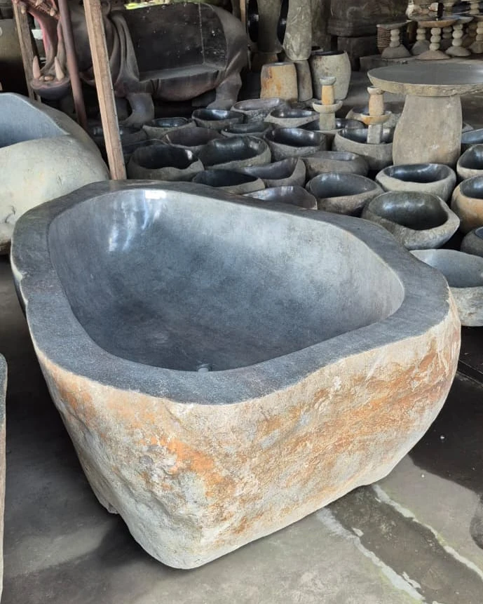 River stone bathtub with a natural raw outer finish, sourced by ExportBali