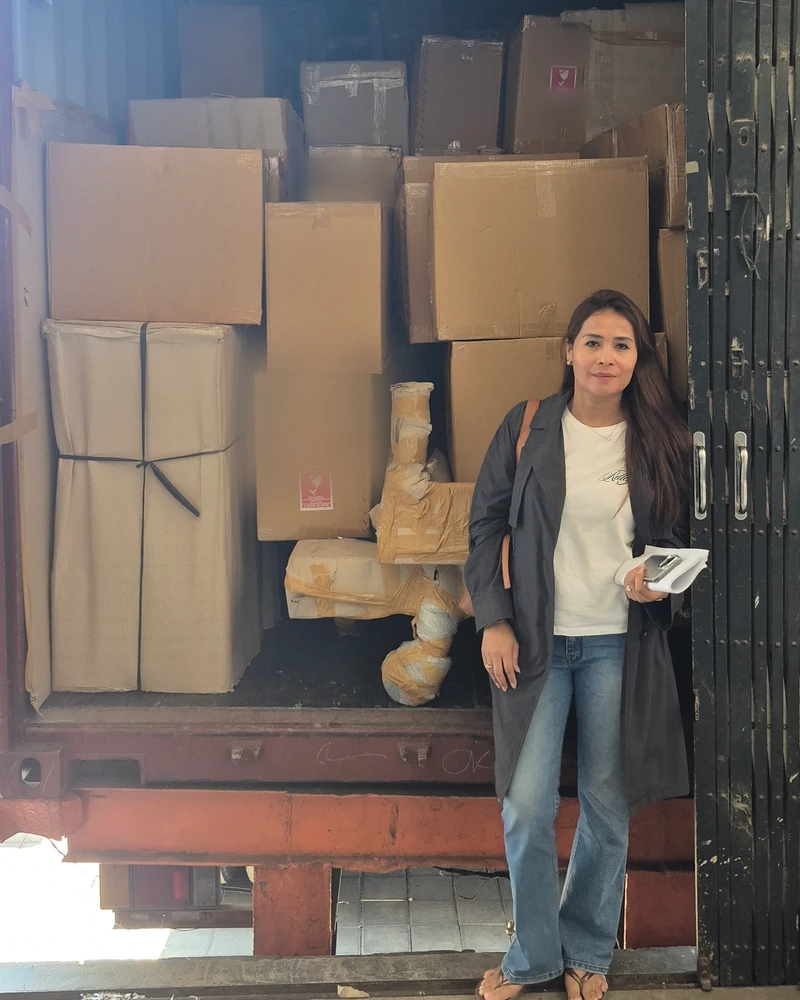 Sasha in front of a loaded export container in Bali