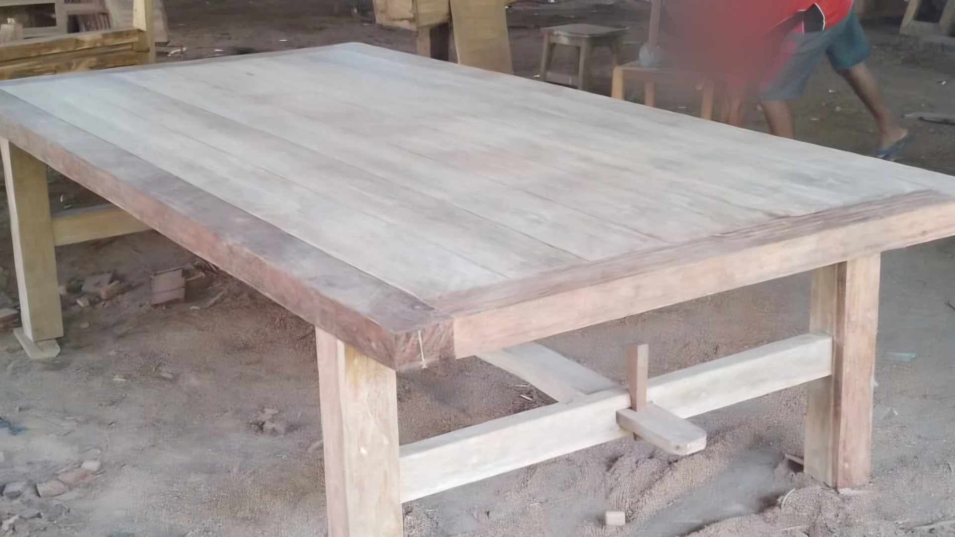 Large solid teak dining table in a Bali furniture workshop, sourced by ExportBali