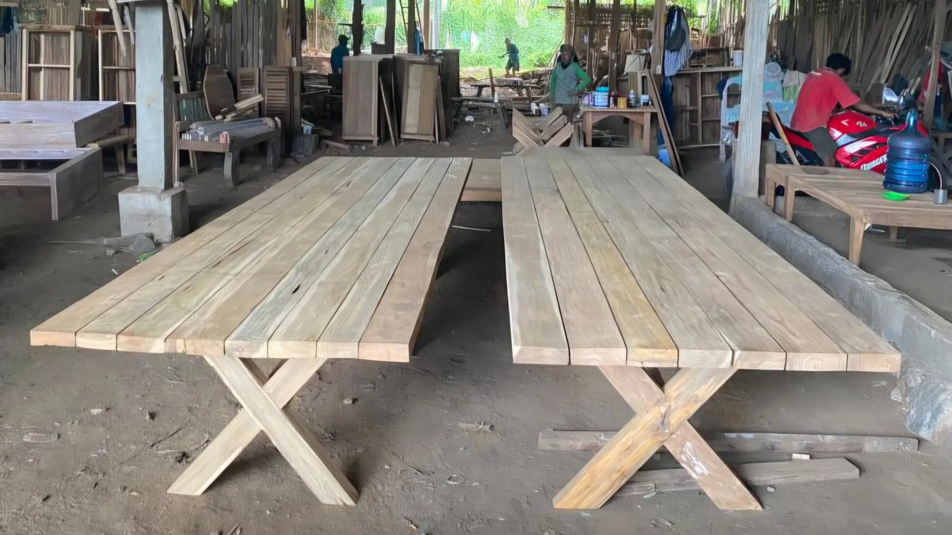 Teak plank tables in production inside a furniture workshop visited by ExportBali